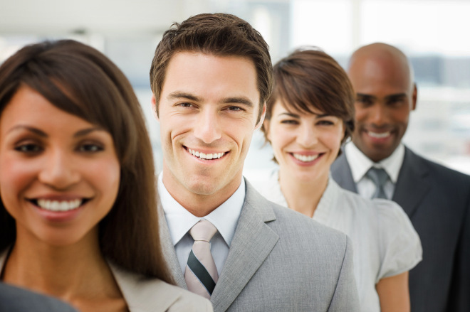 Closeup portrait of happy business group standing together in office