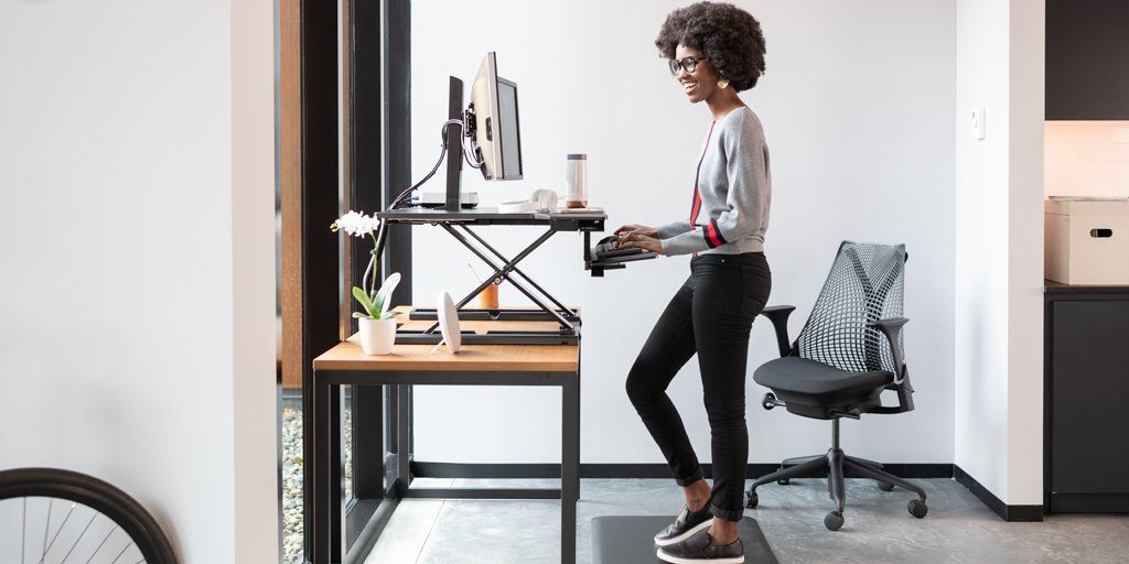 Ergotron Europe women working standing in the office