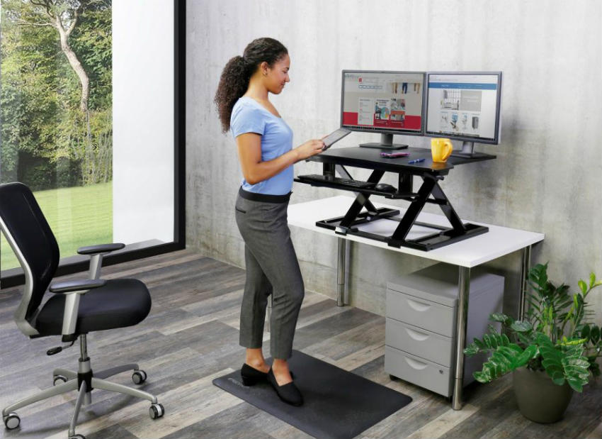 Beautiful office women working while standing Ergotron