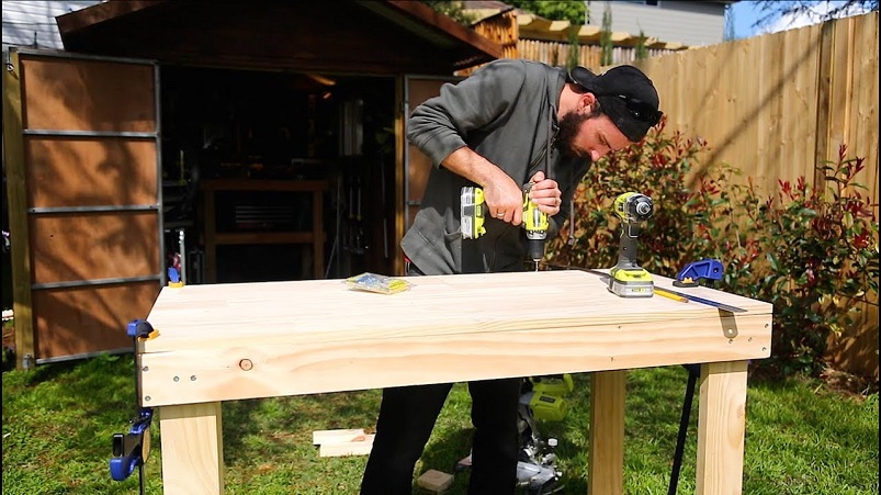 working on workbench in garden shed