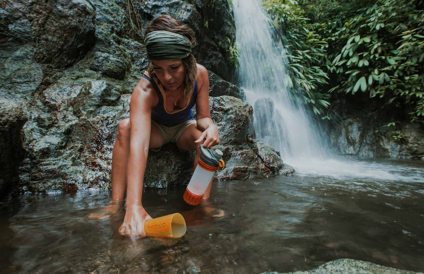 woman-using-water-from-nature