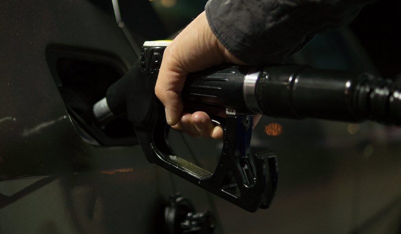 man putting fuel in his car