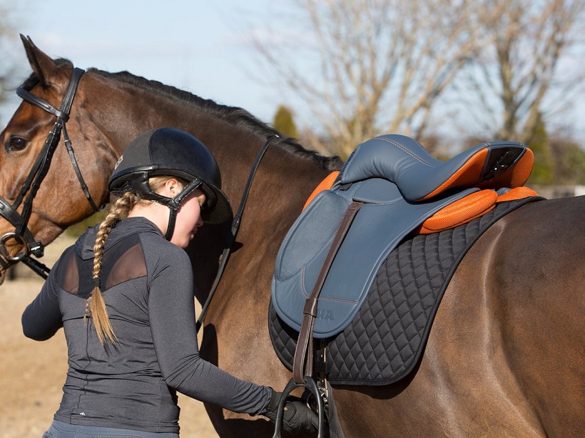 girl and horse with saddle on it