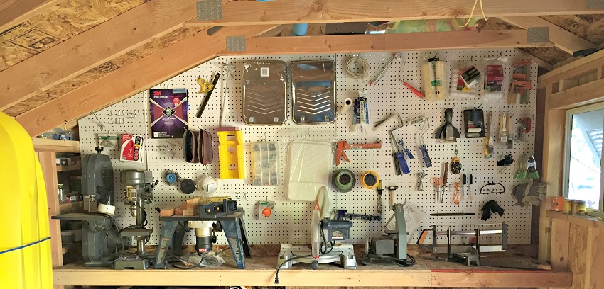 tools hanging on storage hooks in shed
