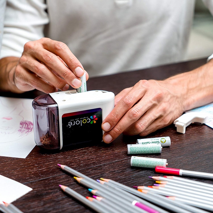 teacher sharpening pencils with electric pencil sharpener 