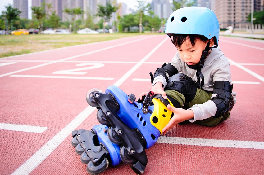 picture of a kid skating with full safety gear