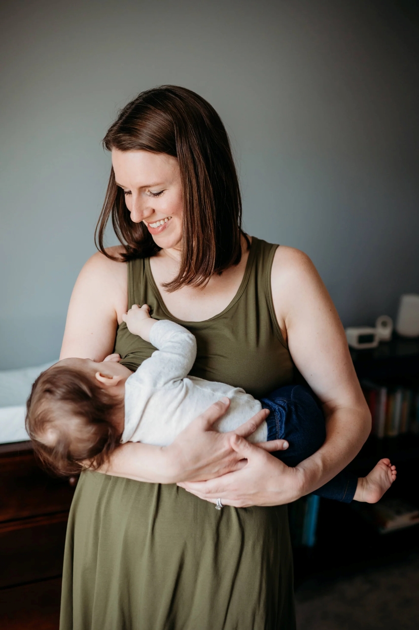 woman wearing a dress while breastfeeding her baby