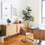 living room with artificial plants, wall art decor, table, chair