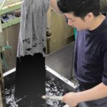 man dyeing pants using clothes dye products