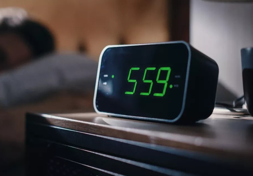 digital alarm clock next to the bed