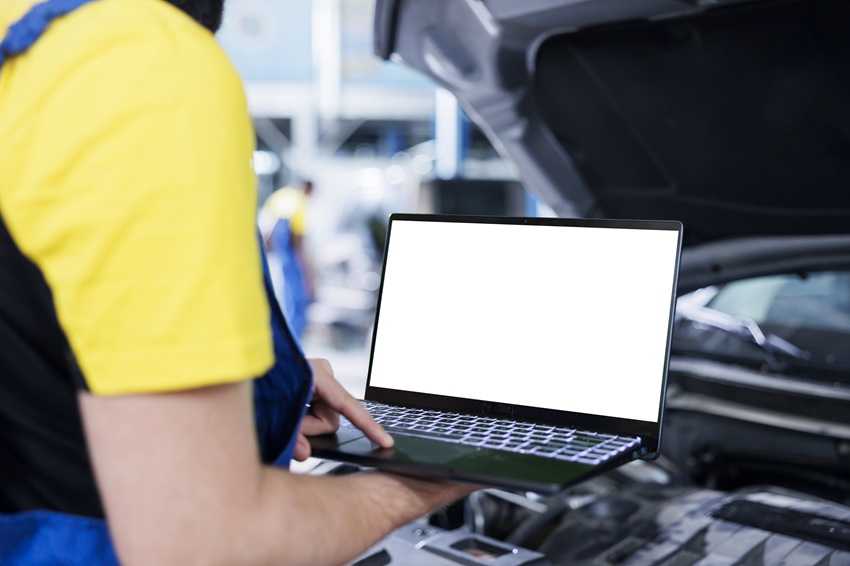 man using his laptop in auto store